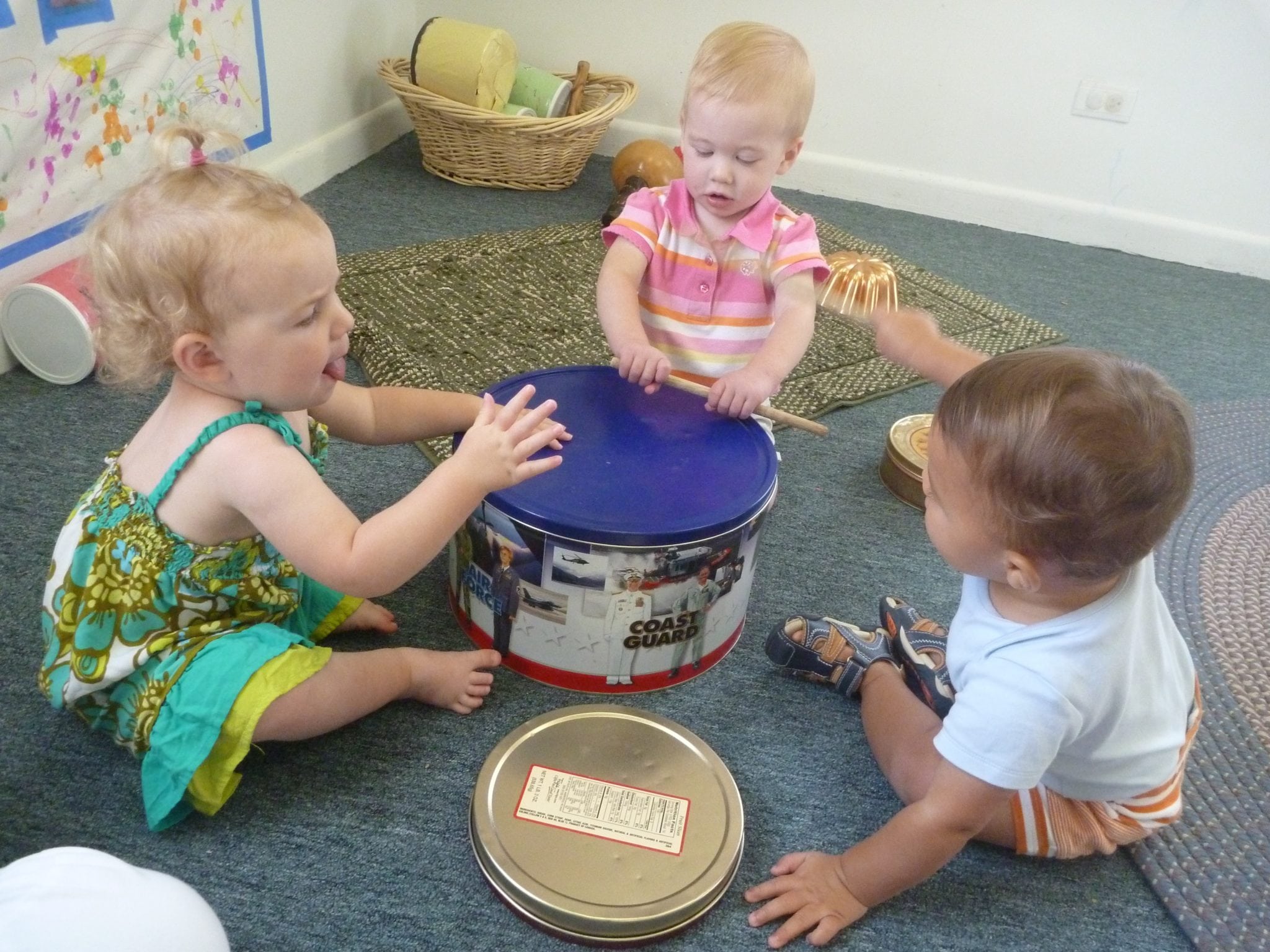 Our Neighborhood Babies banging on the drum